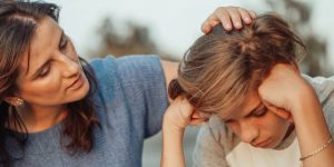 Parent consoling child for Covid trauma