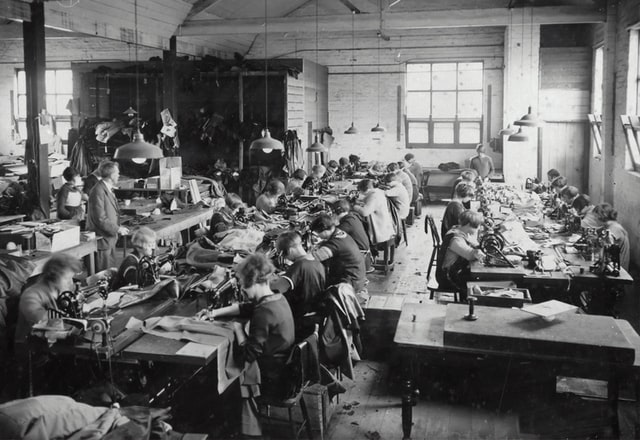 An old picture of people working in a factory